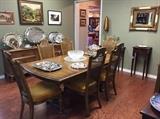 Vintage American dining table with six chairs, Thomasville dresser, art, and silver plate trays.
