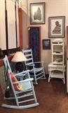 Light blue rockers with side table, wicker shelf and table, screen, and art!