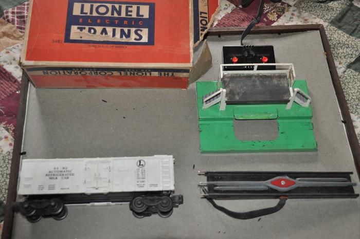 Lionel Decoupler, Lionel Automatic Refrigerated Milk Car 3482 and unloading platform.