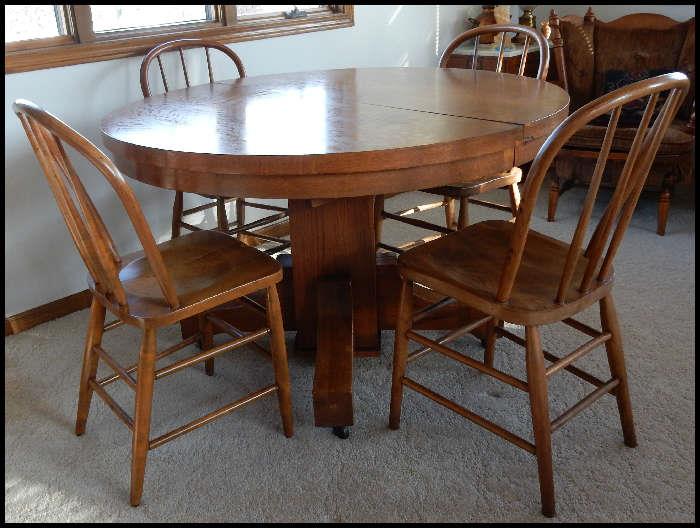 Round oak table with four chairs and leaves