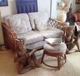 Wood Musicians flank a vintage 1970's Rattan Loveseat and Stool