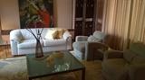 Mid century armchairs, leather sofa, rattan screen and decorative pieces
