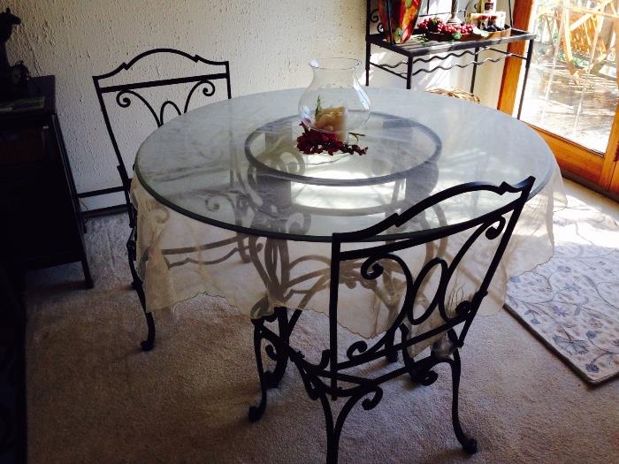 Very nice (heavy) wrought iron kitchen table w/2 chairs.  Cushions available.