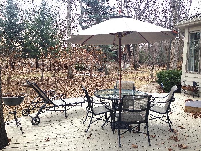 Patio set with round dining table, 4 chairs, umbrella and chaise lounge.  