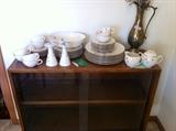 Walnut display cabinet with sliding glass doors.  Lenox china.