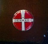 Button imprinted into lounge chair frame.