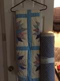            Quilt; one of several bolts of fabric