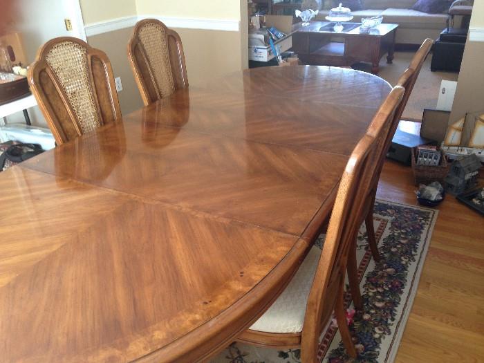 Dining room table with six chairs and leaves.