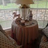 Drape table with assorted smalls and lamp