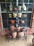 Wrought iron outdoor bakers rack with pottery and smalls