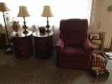 SIDE TABLES AND ONE NEEDS WORK ON TOP, RECLINTER, BOOKS AND PICS BEHIND BOOKS ARE THE  FAMILIES