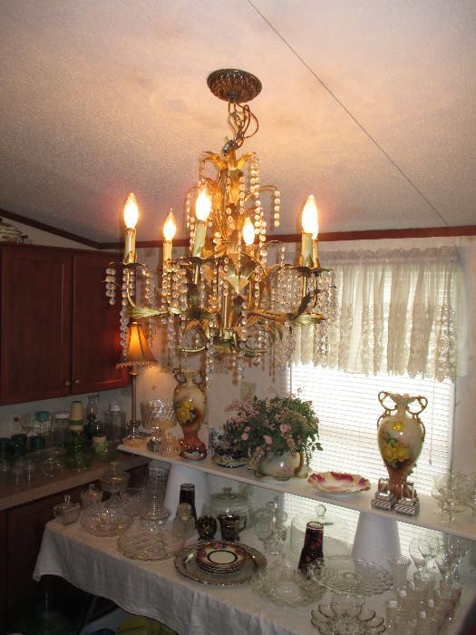 Beautiful Hollywood Regency Chandelier.  Arrangements Will Need To Be Made To Remove Chandelier.  Tall Urns In The Background Have Been Taken By Family.  