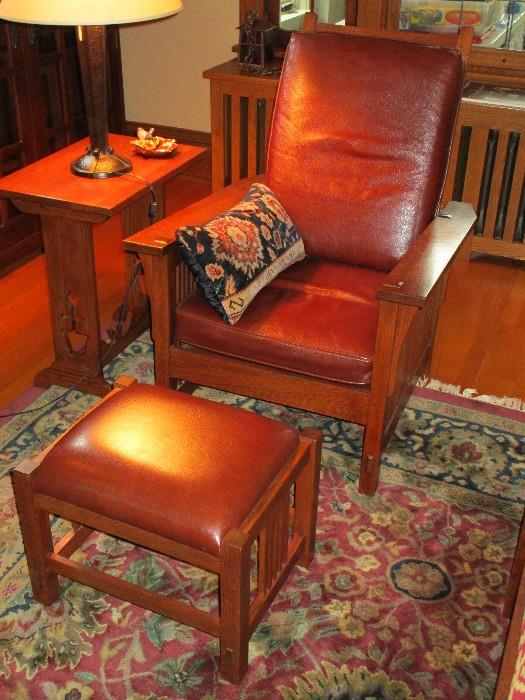 There are two Stickley Compact Spindle Morris chairs and ottomans in leather