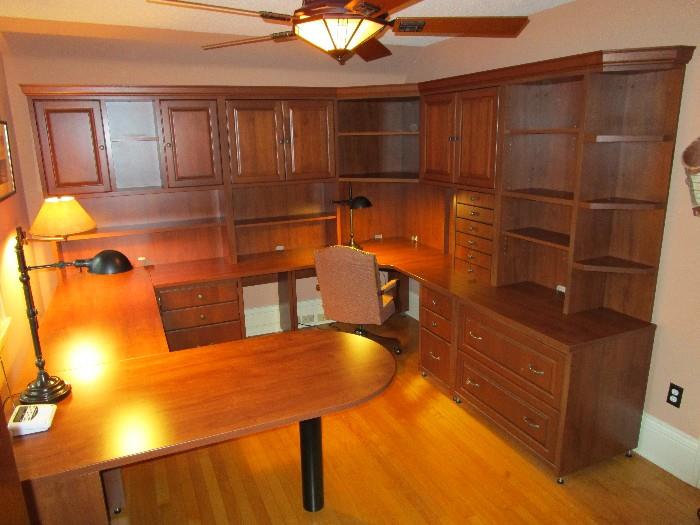 Custom home office designed by Desq of the Twin Cities.  This system occupies 102" x 114" x 102".  It stands at it's tallest sections 82.5" tall.  The peninsula projects 60".  The original manufacturer has supplied a quote to disassemble, move and re-install this system in you home.  Like new!