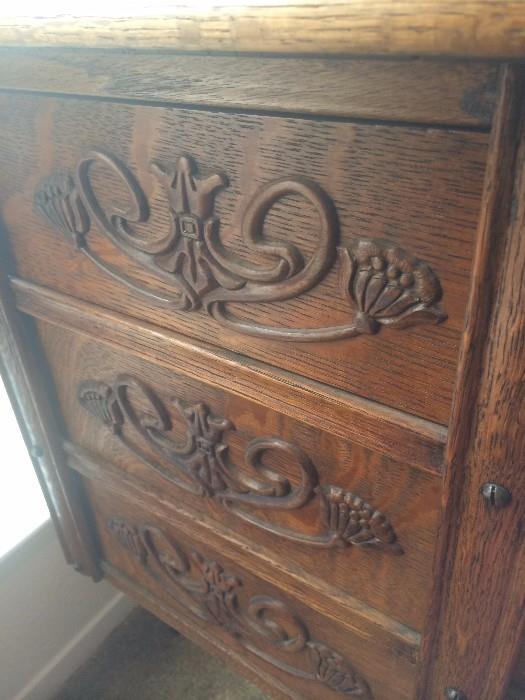 Intricately carved wood on the side of the Singer cabinet