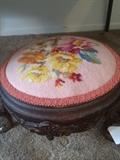       Small antique footstool with needlepoint top