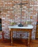 French merchant balance mounted on a marble topped oak stand with brass fittings, 19th century.