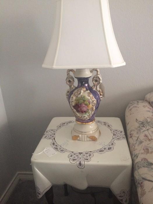         Painted-on cloth table; ornate lamp