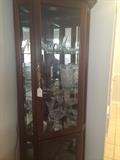 Curio cabinet filled with glass/crystal serving pieces