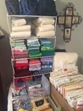 Many patterns, sewing notions, sewing books, and pieces of material