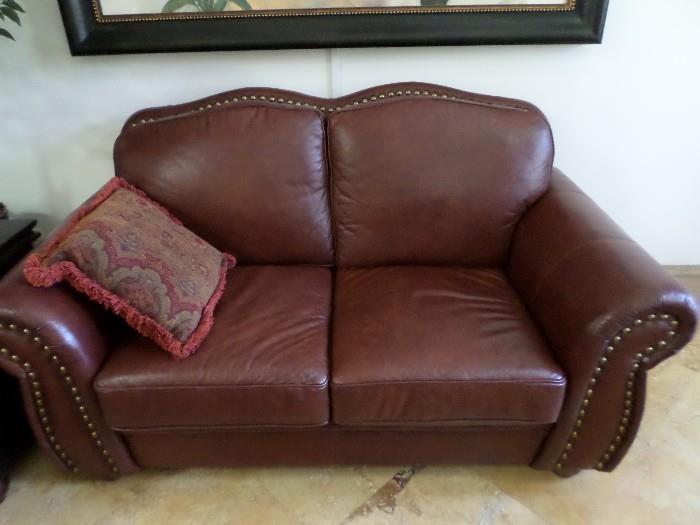 Leather loveseat with brass nailheads