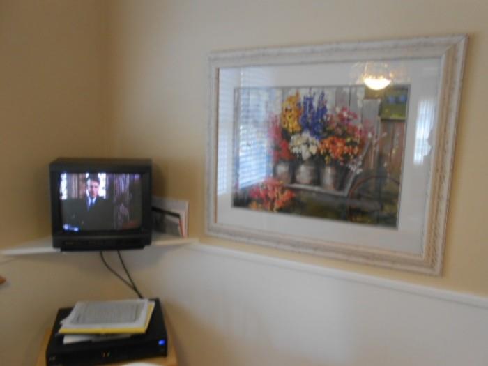 several TV's, and framed wall decor