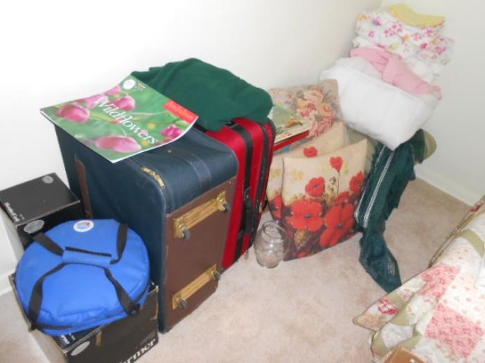 luggage, comforters and pillows