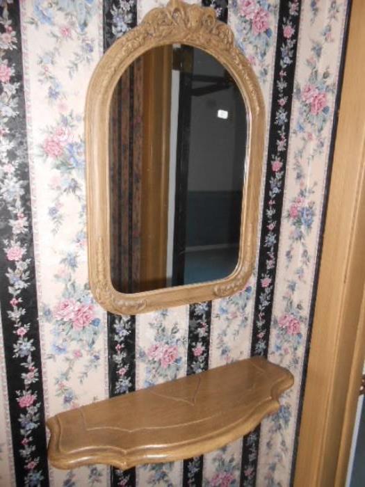 nice arched mirror and bracket shelf pairingf