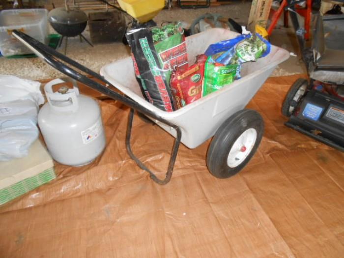 propane tank, lawn supplies, yard cart , smokey joe mini BBq in background