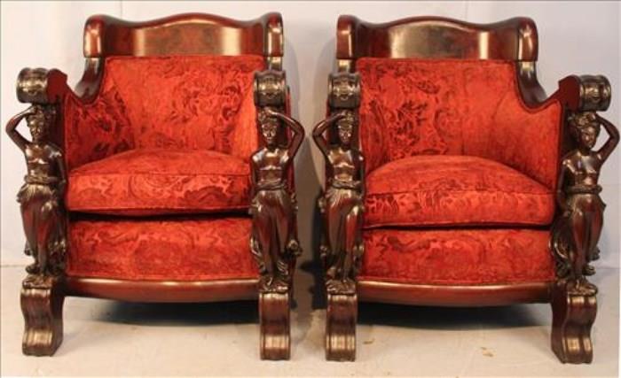 73 - Matched pair of Karpen solid mahogany arm chairs with full figures of women on arms,  41 in. T, 35 in. W, 27 in. D.