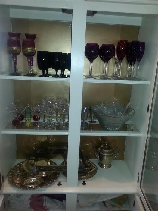 Assortment of goblets, wine glasses, punch bowl and silver plate items