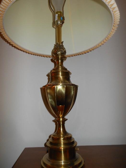 One of two matching brass lamps