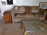 Kreiss sofa with down filled cushions matches armless sofa, glass top coffee table and Haversham end table