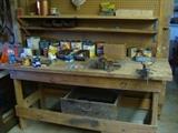 Work bench, vise, cans of assorted sizes of nails and screws, etc.