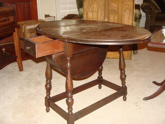Antique oval drop leaf table with unusual 2 drawer combination with a 1/2 barrel drawer