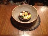 Large wooden bowl with original red paint, stone fruit