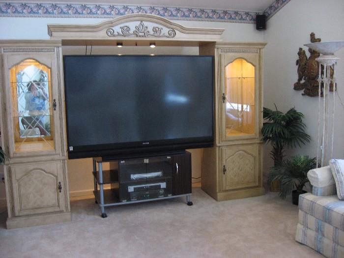 The TV and stand are sold but the entertainment unit is still available. Mitsubishi rear projection TV, yes a second one, a little bigger than the one in the family room, 72" across, 82" on the diagonal