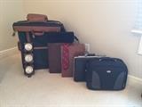 Various suit and brief cases.