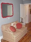 Loveseat , floor brass candlestick, mirror