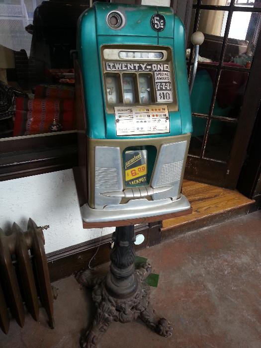 Slot machine with antique stand