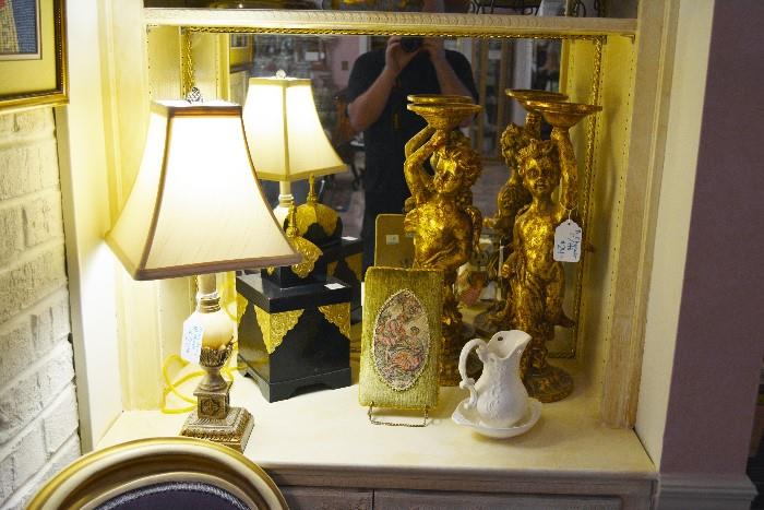 bric-a-brac including cherub candleholders and a marble ball lamp