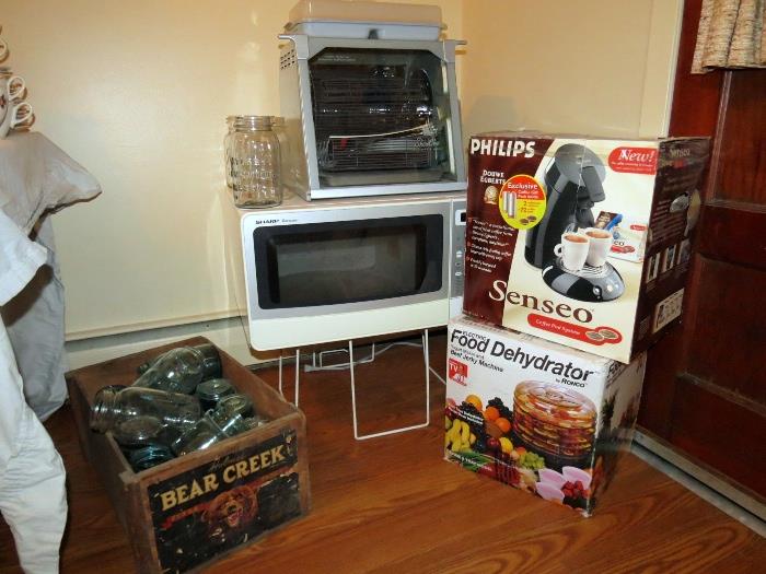 1100 watt Sharp carousel microwave, "set-it and forget it" rotisserie, antique Ball canning jars, brand new food dehydrator and sense coffee maker