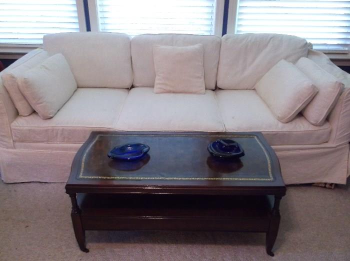 Sofa w/white slip cover and leather top mahogany coffee table
