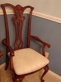 One of the dining chairs in the Chippendale style