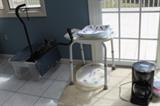 Home care objects. The plastic bin contains canes and wheelchair parts.