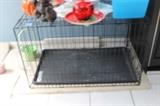 Medium-sized dog crate. Would fit a 30-pound dog comfortably.