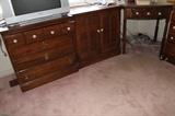 Another dresser, a cabinet and a small desk.