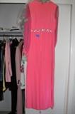 Coral formal dress with sheer sleeves.