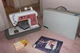 Vintage Singer sewing machine with attachments and booklet.