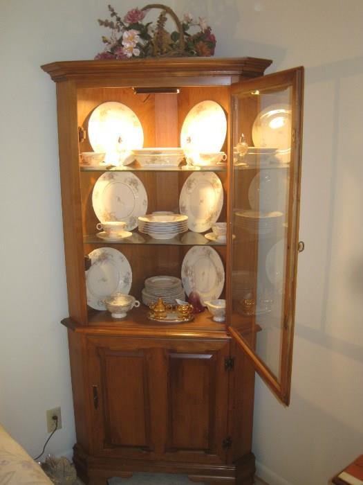 Lovely Tell City lighted corner china cabinet with two glass shelves and large shelf at bottom